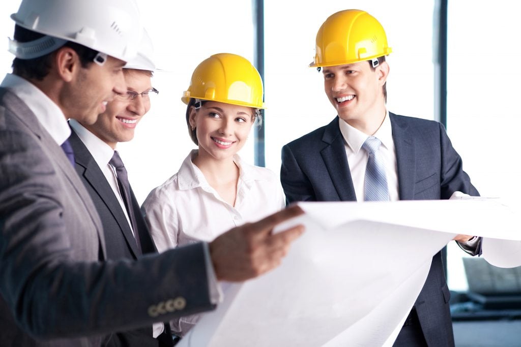 People in helmets on a construction site