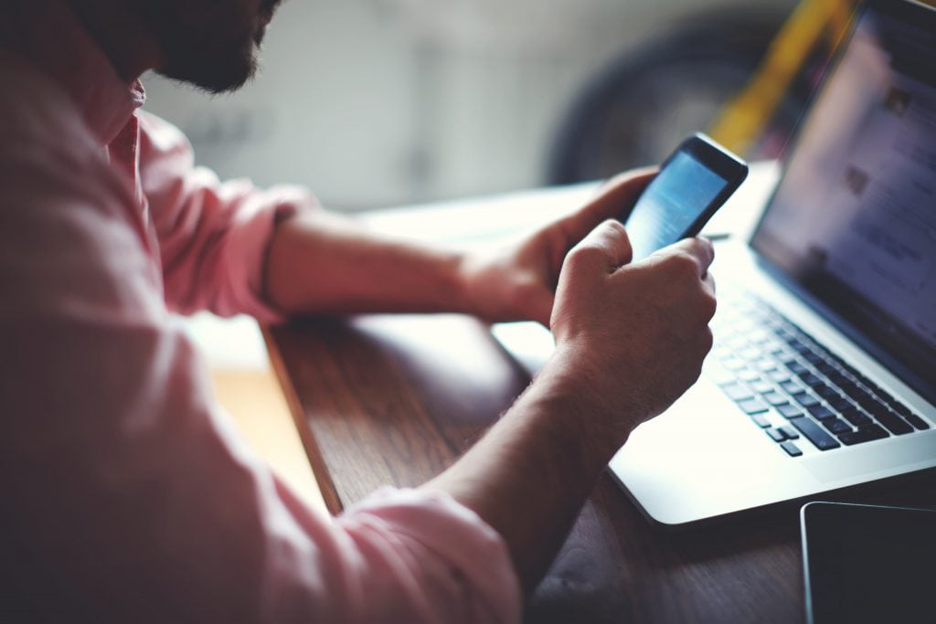 man cellphone laptop