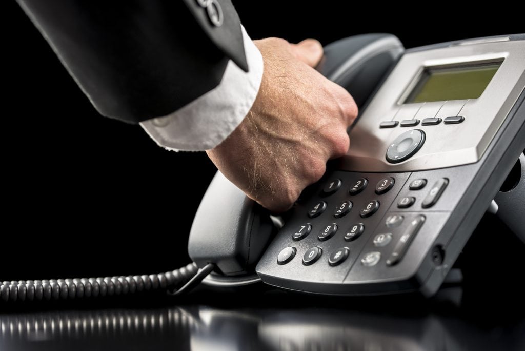 Businessman making a call on a landline
