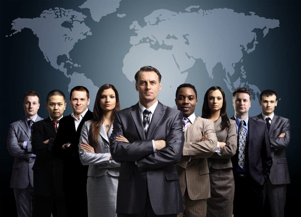 Businessmen standing in front of an earth map