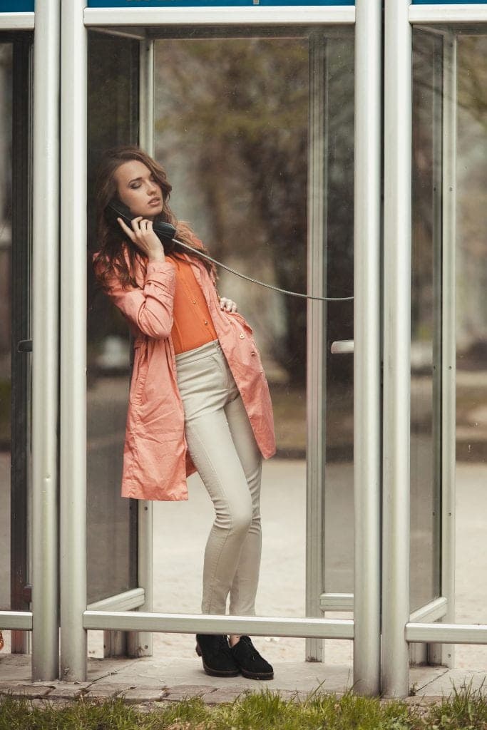 girl talking on the pay phone