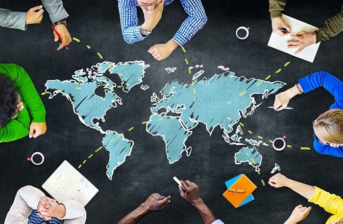 people meeting table world map