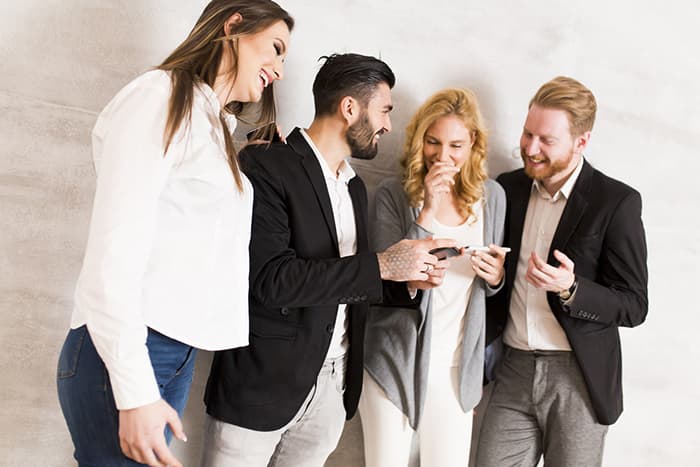 people smiling with cellphones