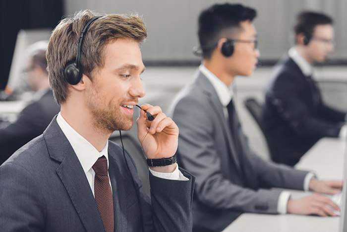 An image of people making international calls in a contact center.