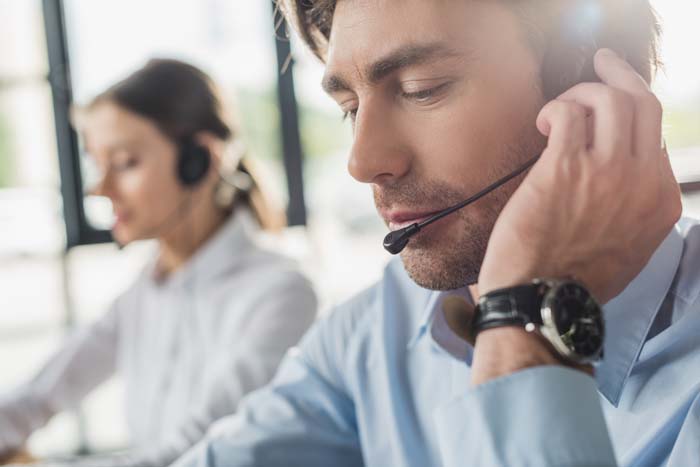 An image of a businessman setting up his call forwarding service.