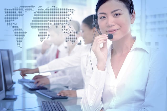 An image of a call center agent using international toll free forwarding.