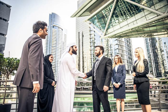 An image of men discussing call forwarding in the UAE.